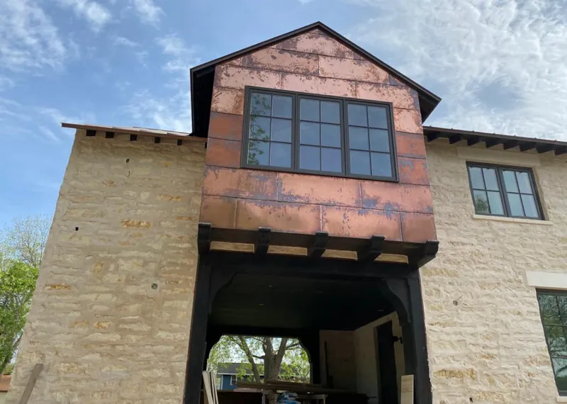 Copper metal panel facade on a stone building for Roof Repair in Sun City