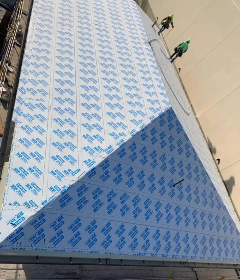 Professional roofers installing underlayment on a metal roof in Sun City